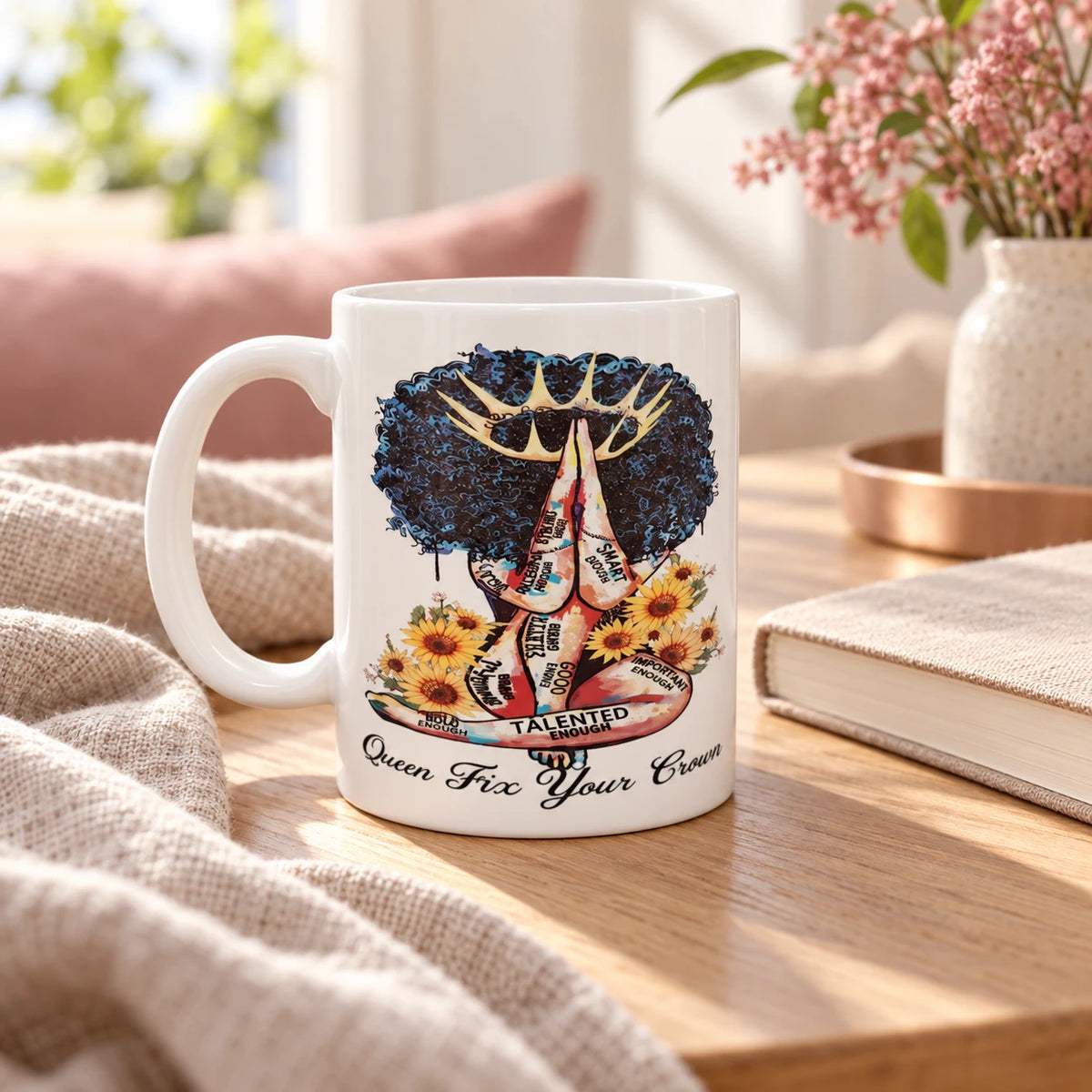 Lifestyle mockup of the Queen Fix Your Crown mug beside a journal in a warm home setting